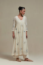 Off white cotton Chanderi kurta dress set with delicate embroidered flowers and blue & beige hand block printed appliqué motifs, highlighted with sequins and multi coloured beads.