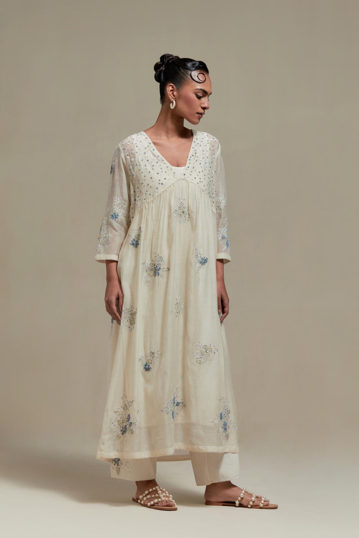 Off white cotton Chanderi kurta dress set with delicate embroidered flowers and blue & beige hand block printed appliqué motifs, highlighted with sequins and multi coloured beads.