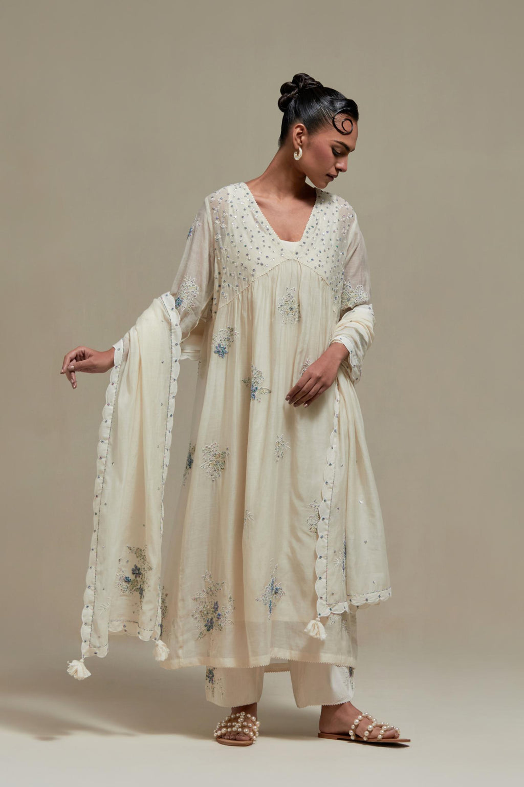 Off white cotton Chanderi kurta dress set with delicate embroidered flowers and blue & beige hand block printed appliqué motifs, highlighted with sequins and multi coloured beads.