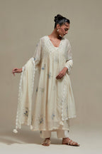 Off white cotton Chanderi kurta dress set with delicate embroidered flowers and blue & beige hand block printed appliqué motifs, highlighted with sequins and multi coloured beads.