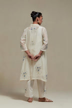 Off white cotton Chanderi short shirt-kurta set with all-over blue & beige hand block printed appliqué flowers, highlighted with sequins and multi-coloured beads.