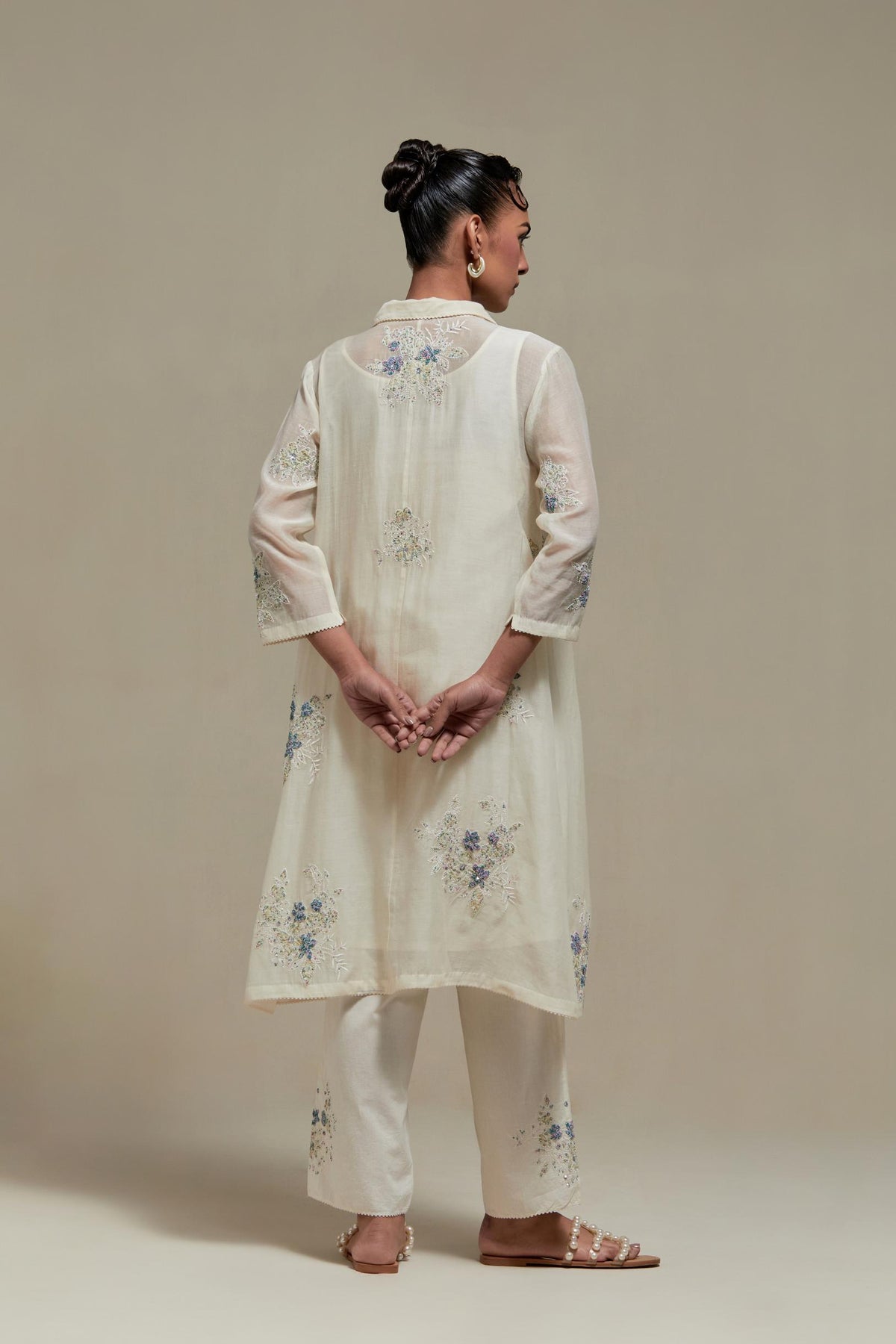 Off white cotton Chanderi short shirt-kurta set with all-over blue & beige hand block printed appliqué flowers, highlighted with sequins and multi-coloured beads.
