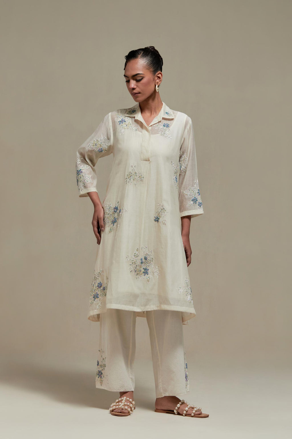Off white cotton Chanderi short shirt-kurta set with all-over blue & beige hand block printed appliqué flowers, highlighted with sequins and multi-coloured beads.
