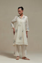 Off white cotton Chanderi short shirt-kurta set with all-over blue & beige hand block printed appliqué flowers, highlighted with sequins and multi-coloured beads.