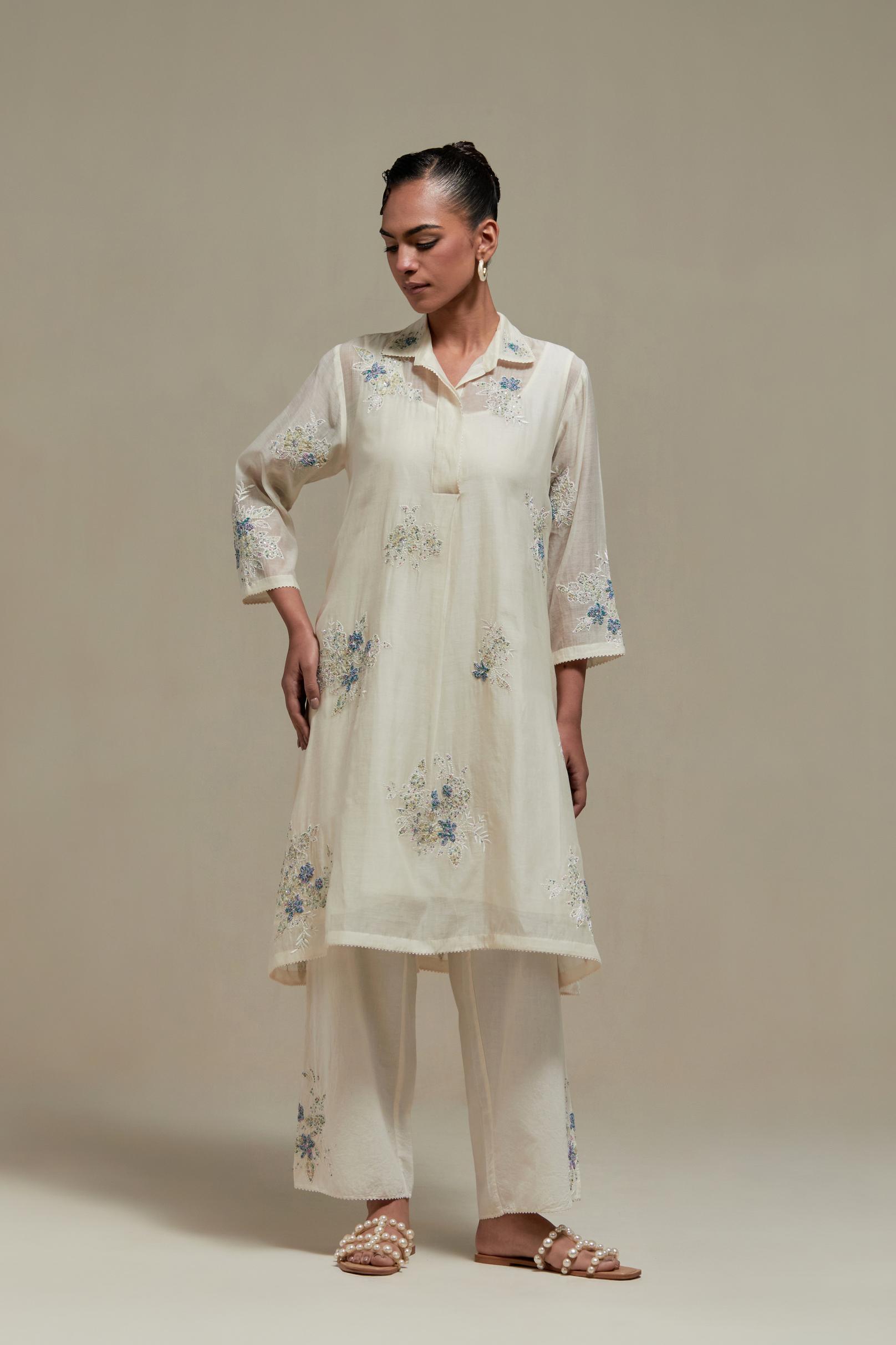 Off white cotton Chanderi short shirt-kurta set with all-over blue & beige hand block printed appliqué flowers, highlighted with sequins and multi-coloured beads.