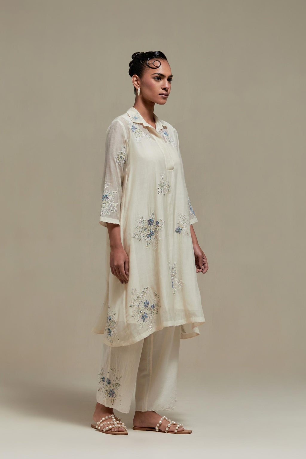 Off white cotton Chanderi short shirt-kurta set with all-over blue & beige hand block printed appliqué flowers, highlighted with sequins and multi-coloured beads.