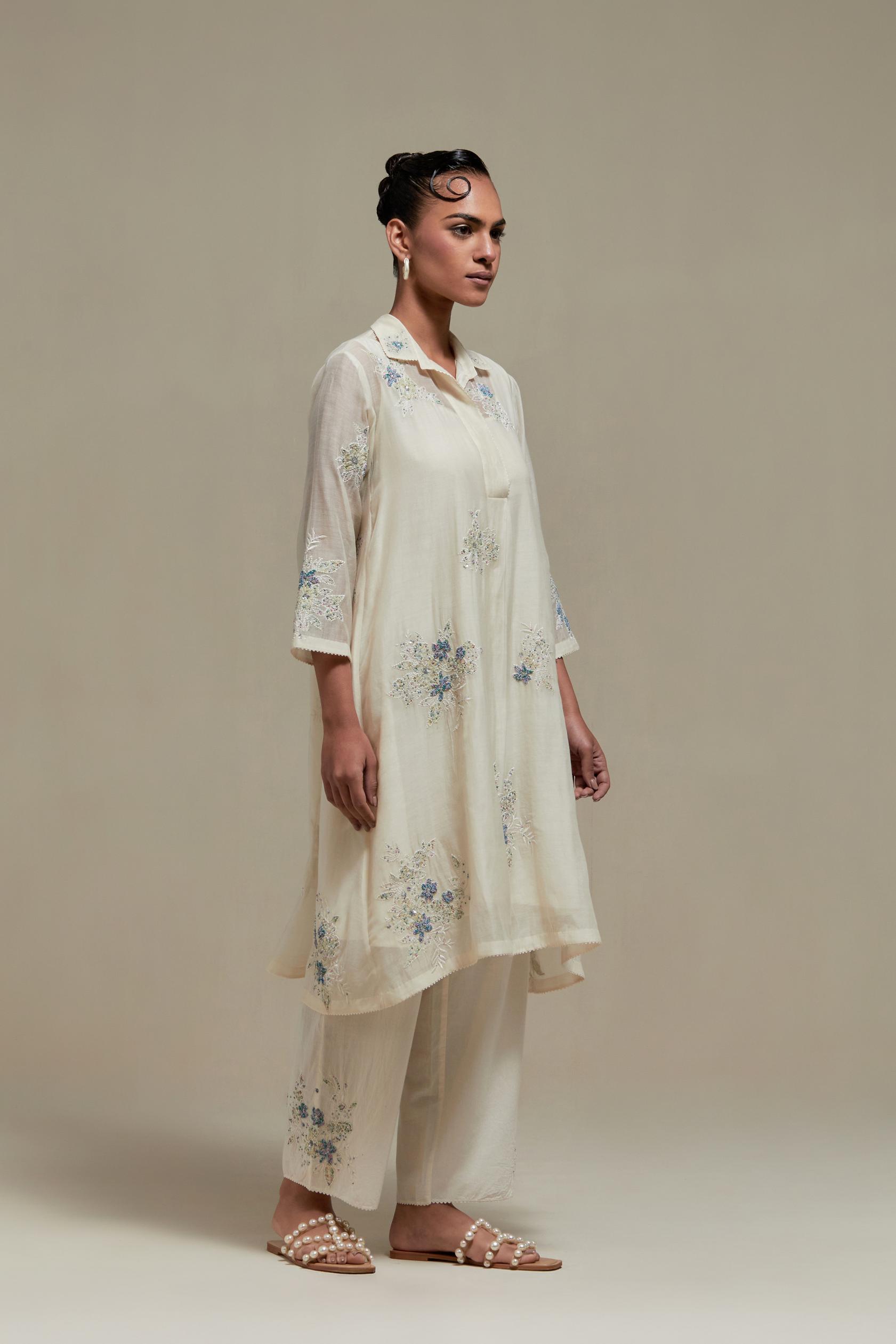 Off white cotton Chanderi short shirt-kurta set with all-over blue & beige hand block printed appliqué flowers, highlighted with sequins and multi-coloured beads.