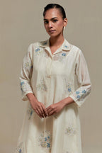 Off white cotton Chanderi short shirt-kurta set with all-over blue & beige hand block printed appliqué flowers, highlighted with sequins and multi-coloured beads.