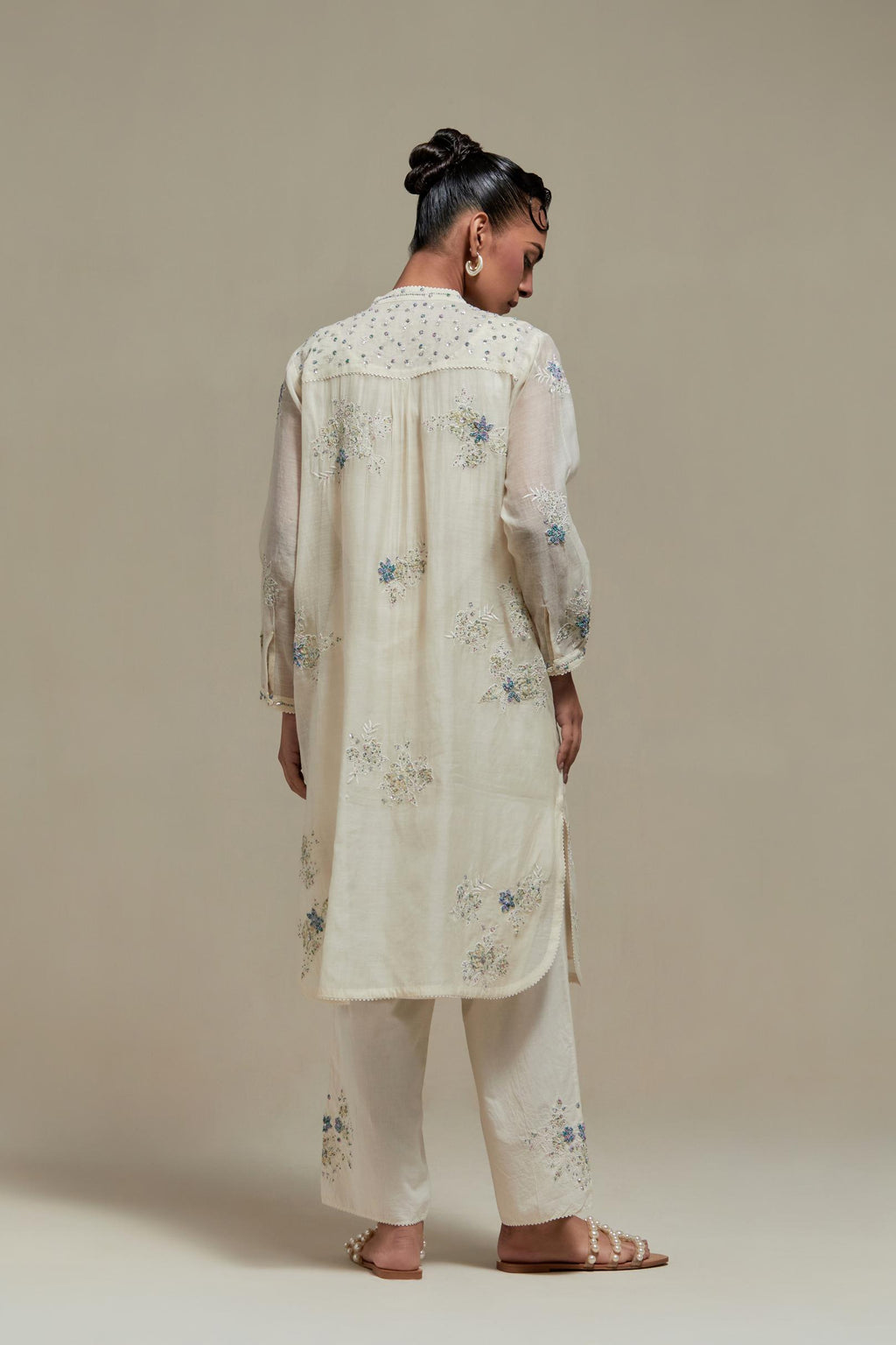Off white cotton Chanderi short kurta set with all-over blue & beige hand block printed appliqué, highlighted with sequins and multi coloured beads.