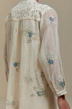 Off white cotton Chanderi short kurta set with all-over blue & beige hand block printed appliqué, highlighted with sequins and multi coloured beads.