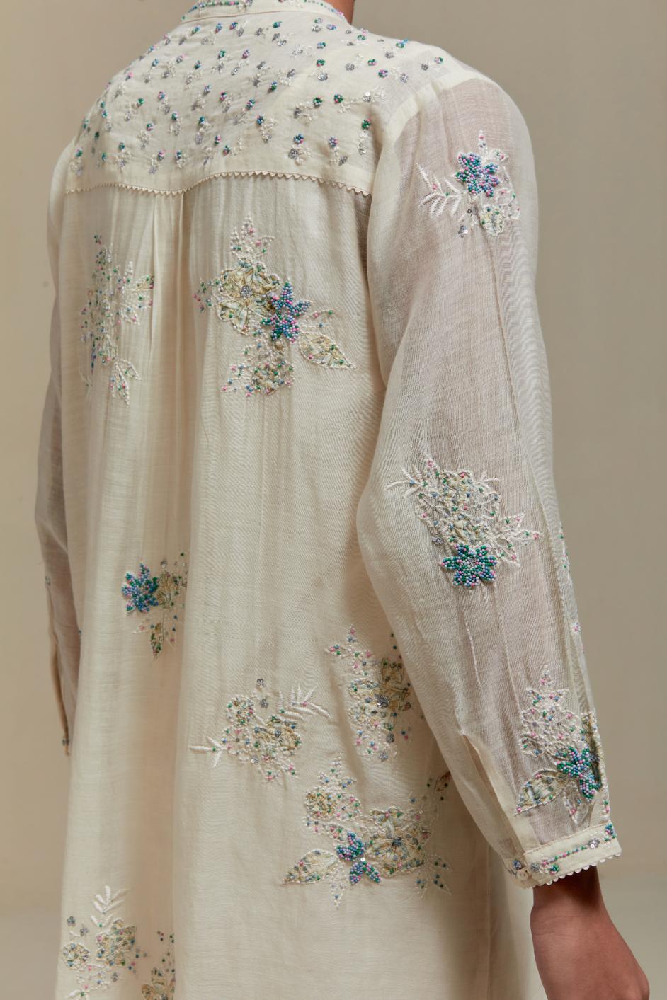 Off white cotton Chanderi short kurta set with all-over blue & beige hand block printed appliqué, highlighted with sequins and multi coloured beads.