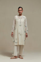 Off white cotton Chanderi short kurta set with all-over blue & beige hand block printed appliqué, highlighted with sequins and multi coloured beads.