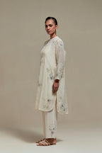 Off white cotton Chanderi short kurta set with all-over blue & beige hand block printed appliqué, highlighted with sequins and multi coloured beads.