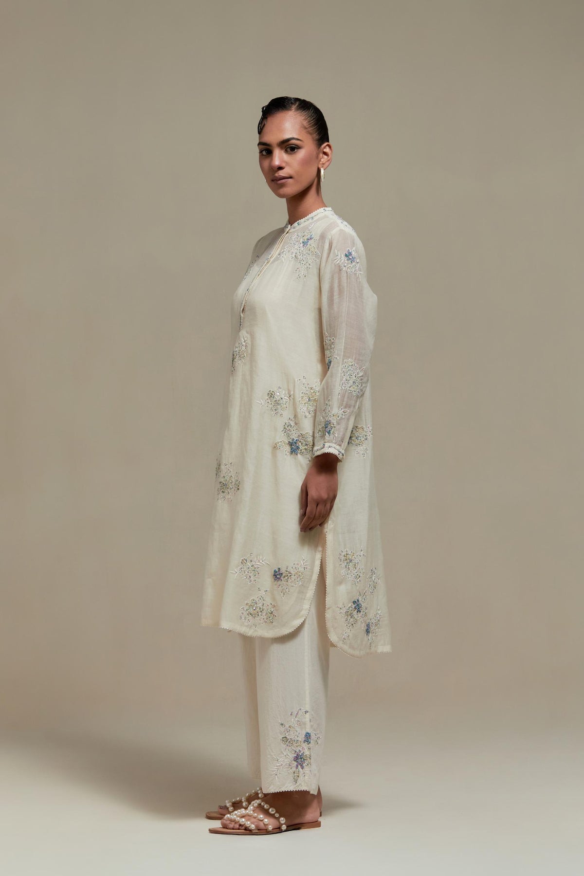 Off white cotton Chanderi short kurta set with all-over blue & beige hand block printed appliqué, highlighted with sequins and multi coloured beads.