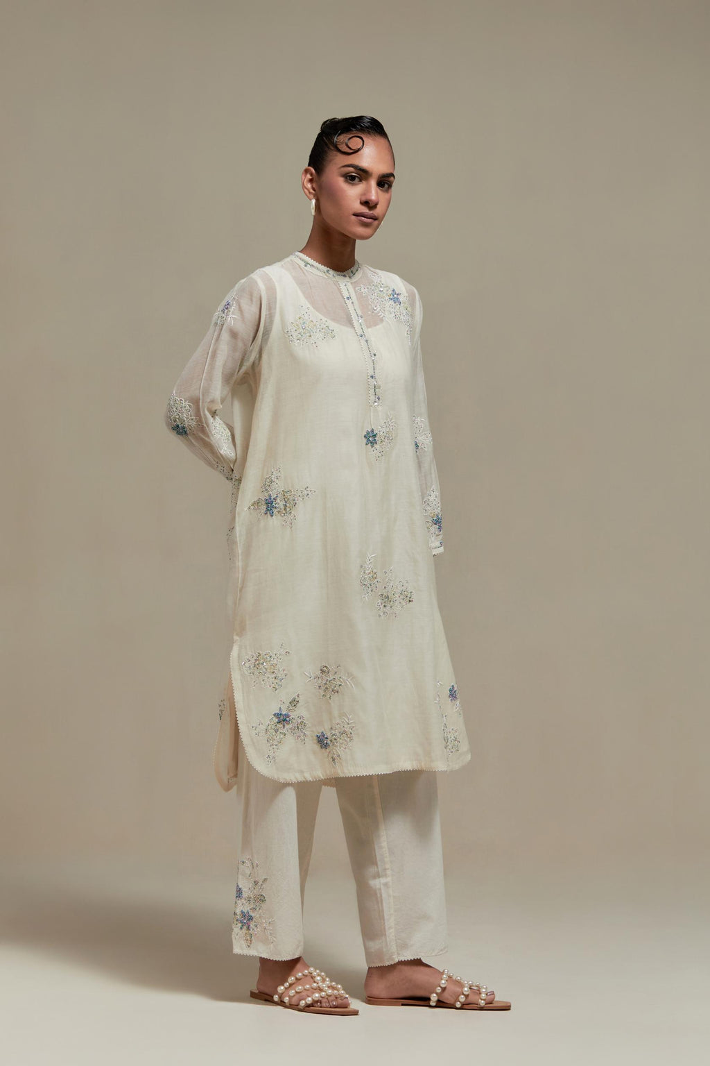 Off white cotton Chanderi short kurta set with all-over blue & beige hand block printed appliqué, highlighted with sequins and multi coloured beads.