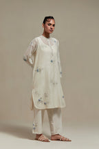 Off white cotton Chanderi short kurta set with all-over blue & beige hand block printed appliqué, highlighted with sequins and multi coloured beads.