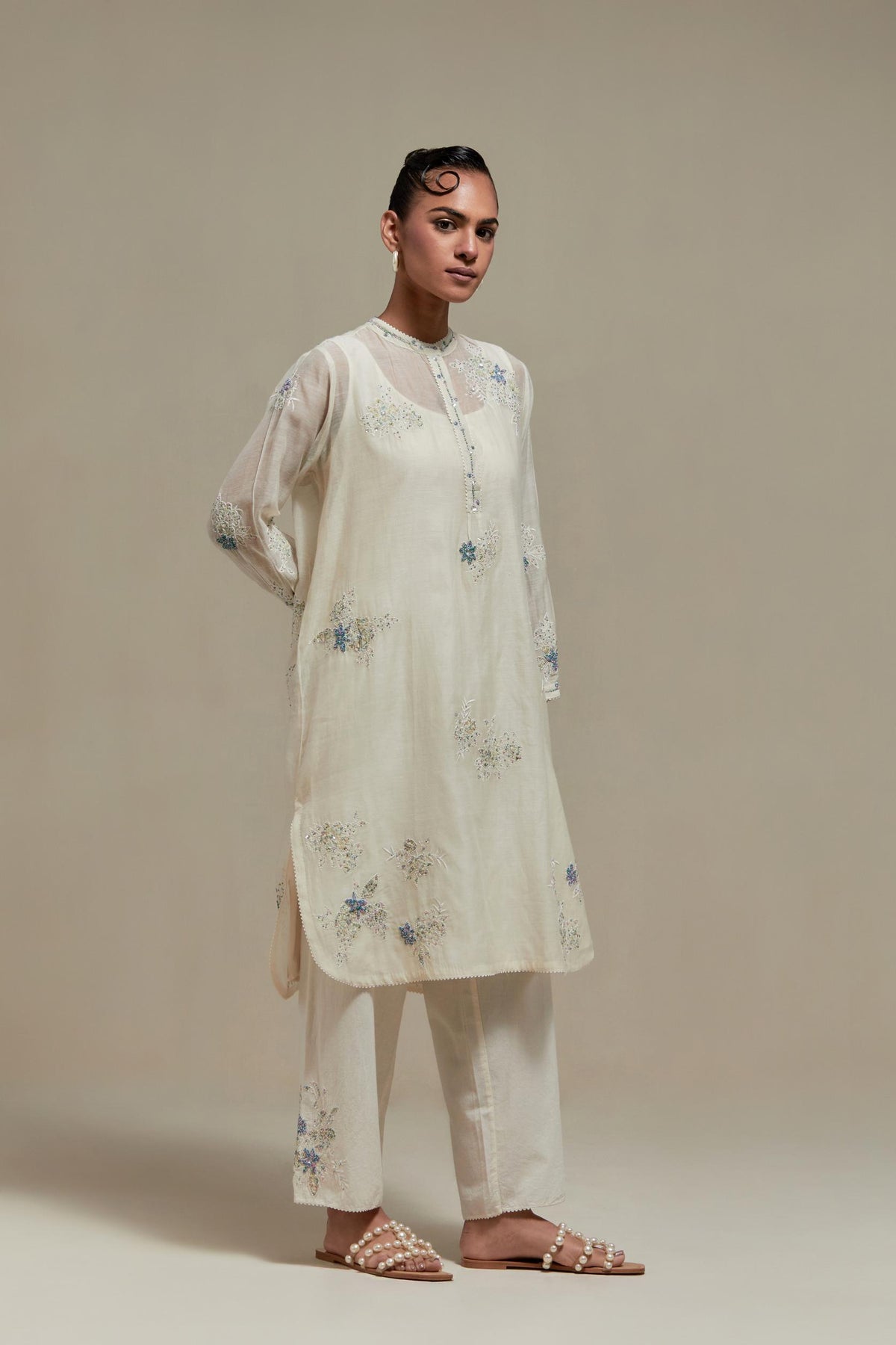 Off white cotton Chanderi short kurta set with all-over blue & beige hand block printed appliqué, highlighted with sequins and multi coloured beads.