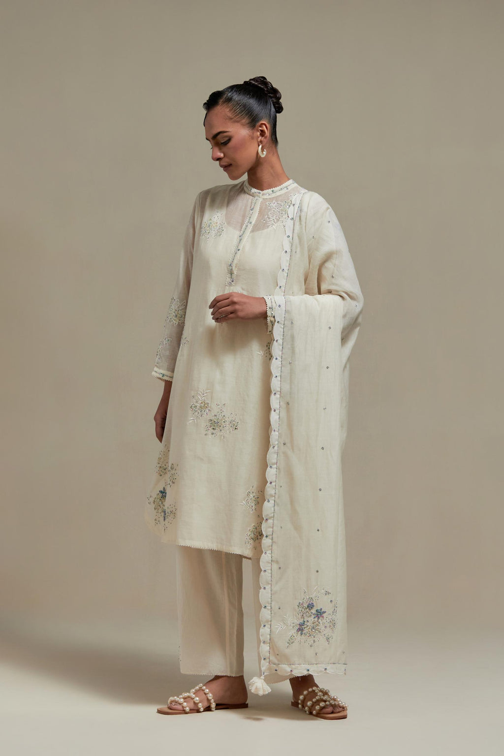 Off white cotton Chanderi short kurta set with all-over blue & beige hand block printed appliqué, highlighted with sequins and multi coloured beads.