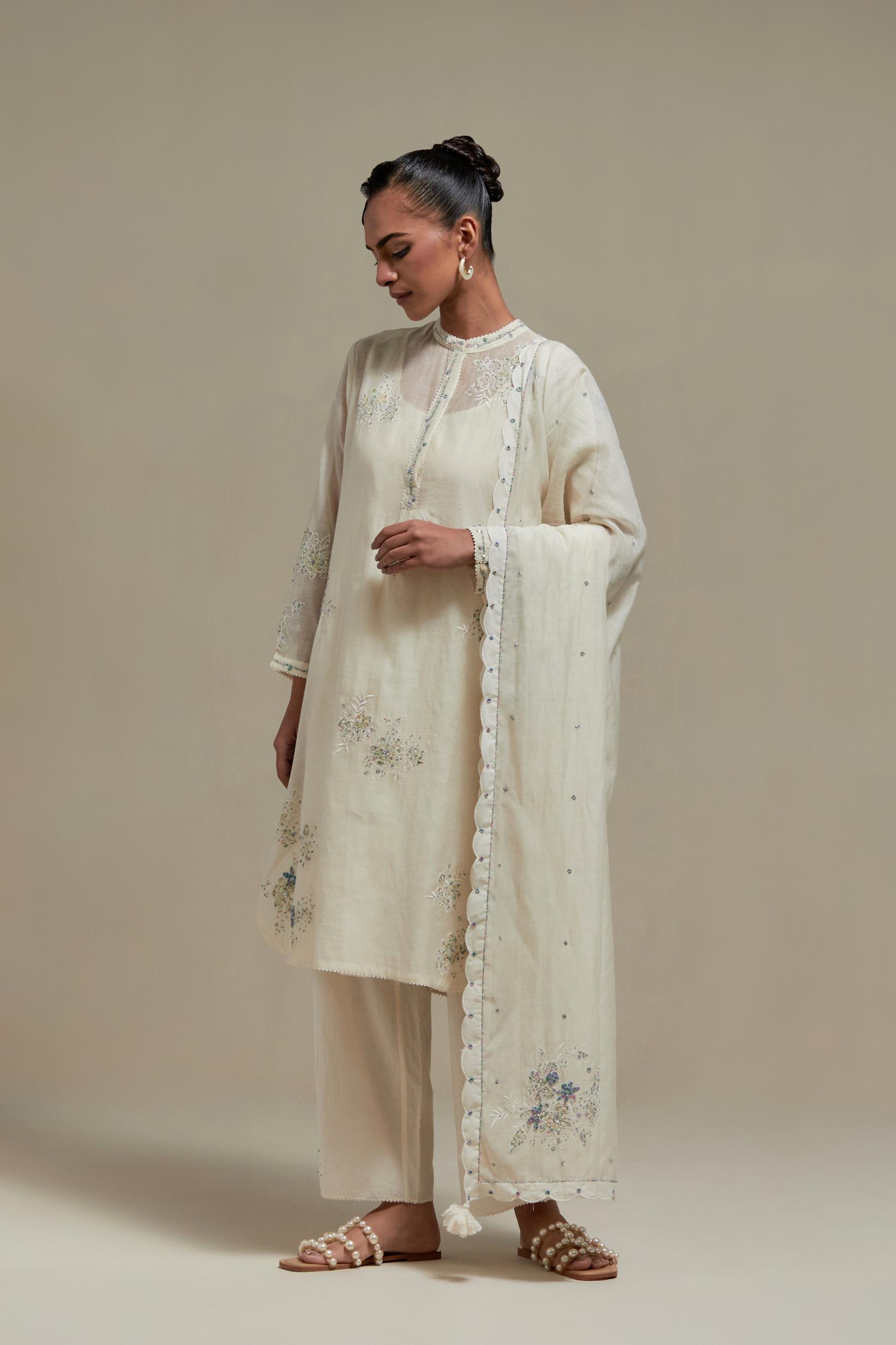 Off white cotton Chanderi short kurta set with all-over blue & beige hand block printed appliqué, highlighted with sequins and multi coloured beads.