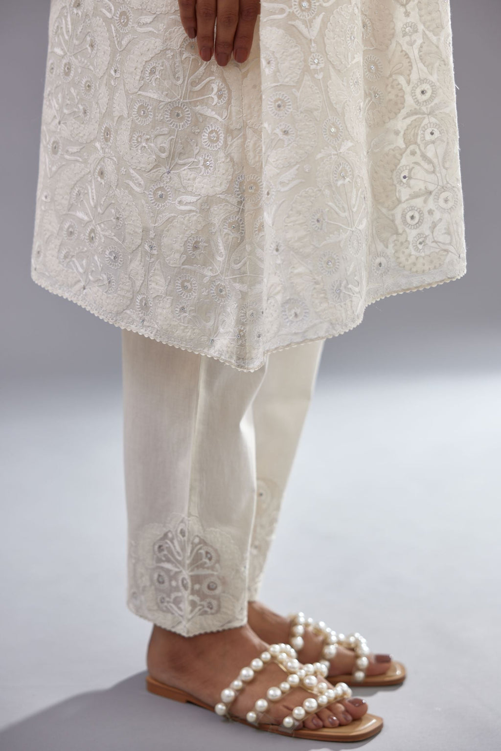 Off white short easy fit, straight hem kurta set with all-over trellis jaal appliqué, highlighted with sequins.