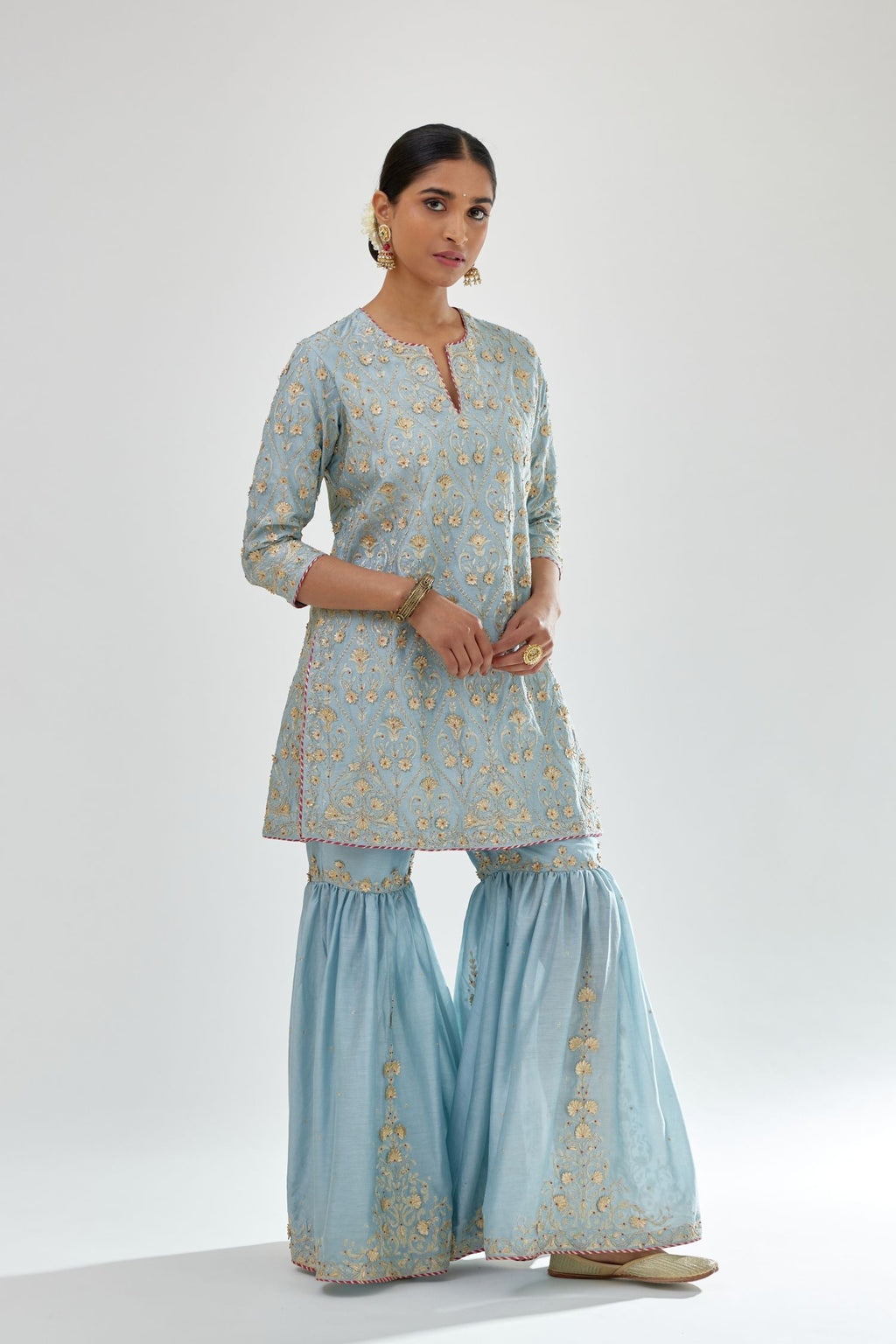 Blue short kurta set detailed with all-over zari, dori, sequins and gota embroidery.