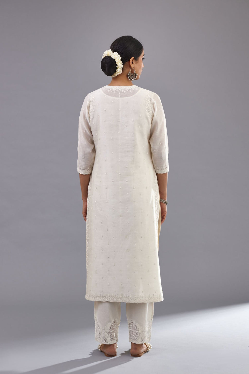 Off white silk chanderi straight kurta with dori and silk thread embroidery at the neck, armholes, hem and sleeve cuffs.
