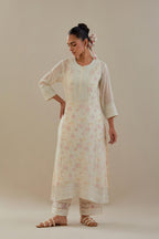 Off white cotton chanderi straight kurta set with heavy embroidered button placket neckline and delicate bead, tassel work at side panel joint seams.