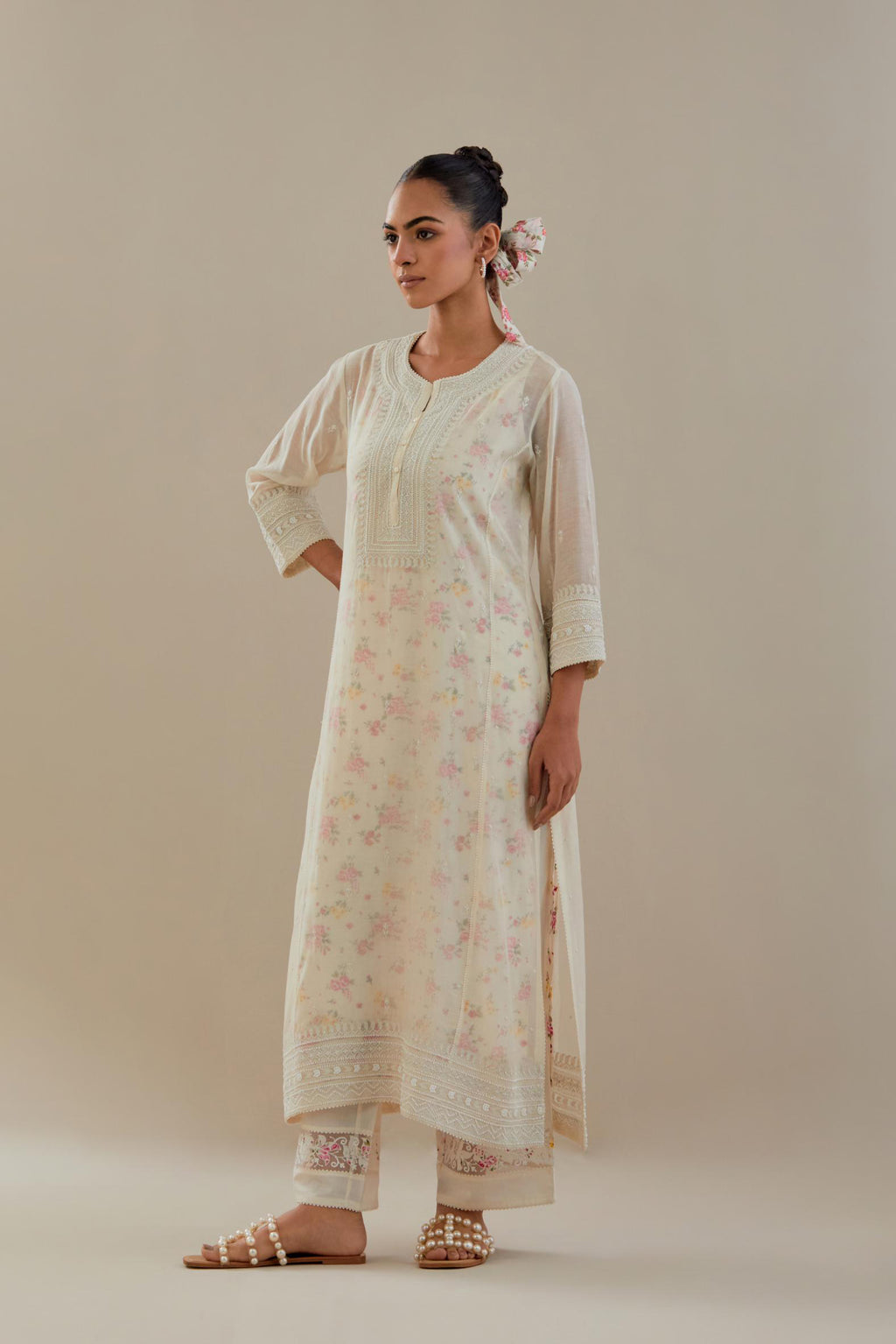 Off white cotton chanderi straight kurta set with heavy embroidered button placket neckline and delicate bead, tassel work at side panel joint seams.