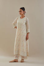 Off white cotton chanderi straight kurta set with heavy embroidered button placket neckline and delicate bead, tassel work at side panel joint seams.