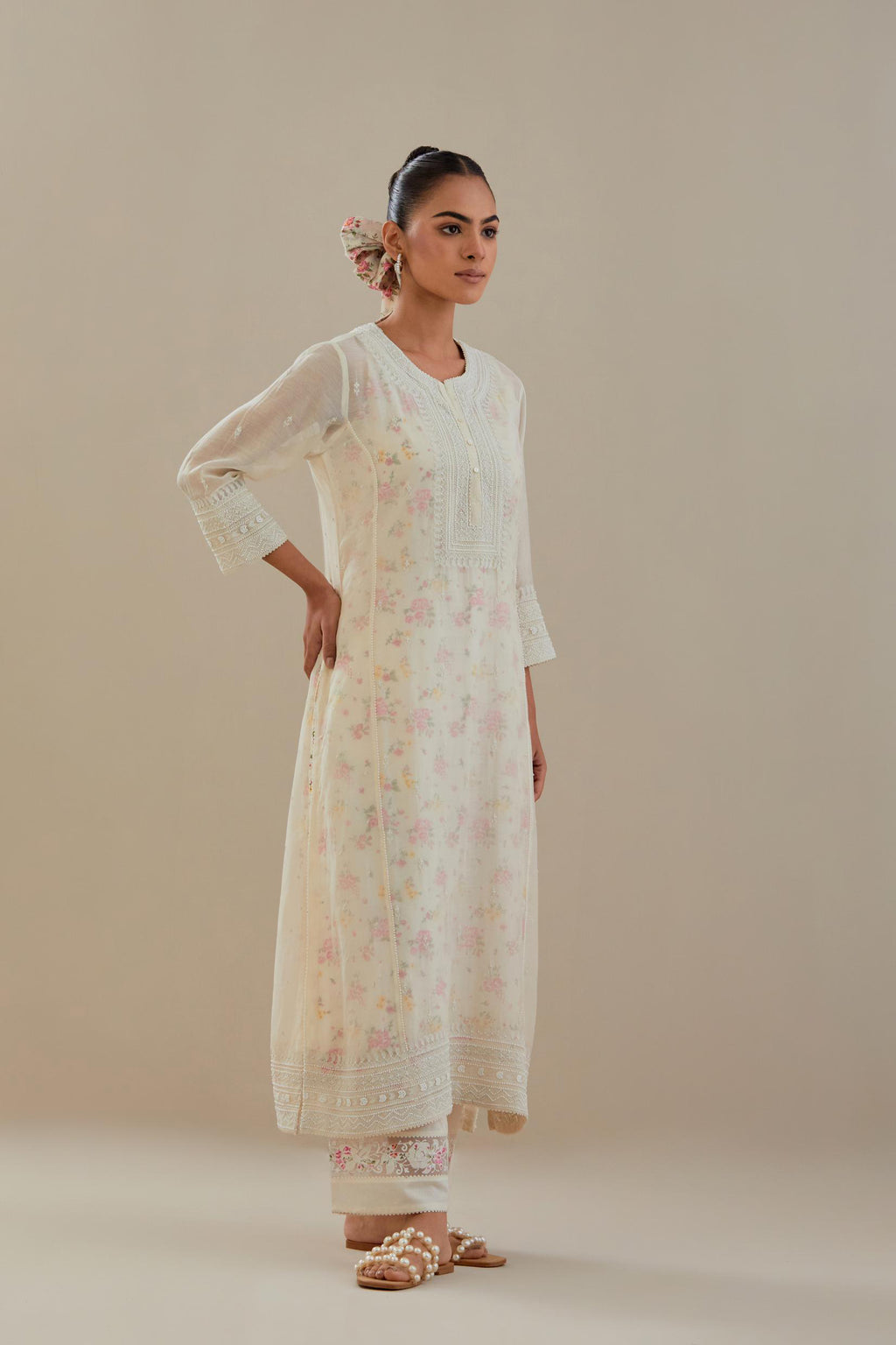 Off white cotton chanderi straight kurta set with heavy embroidered button placket neckline and delicate bead, tassel work at side panel joint seams.