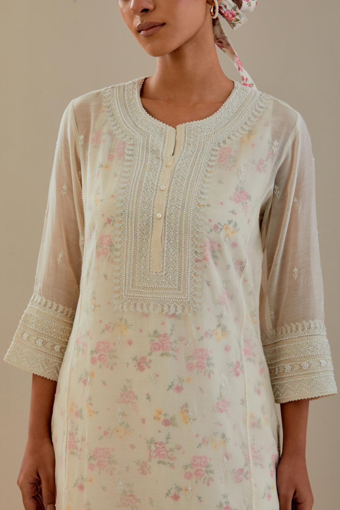Off white cotton chanderi straight kurta set with heavy embroidered button placket neckline and delicate bead, tassel work at side panel joint seams.