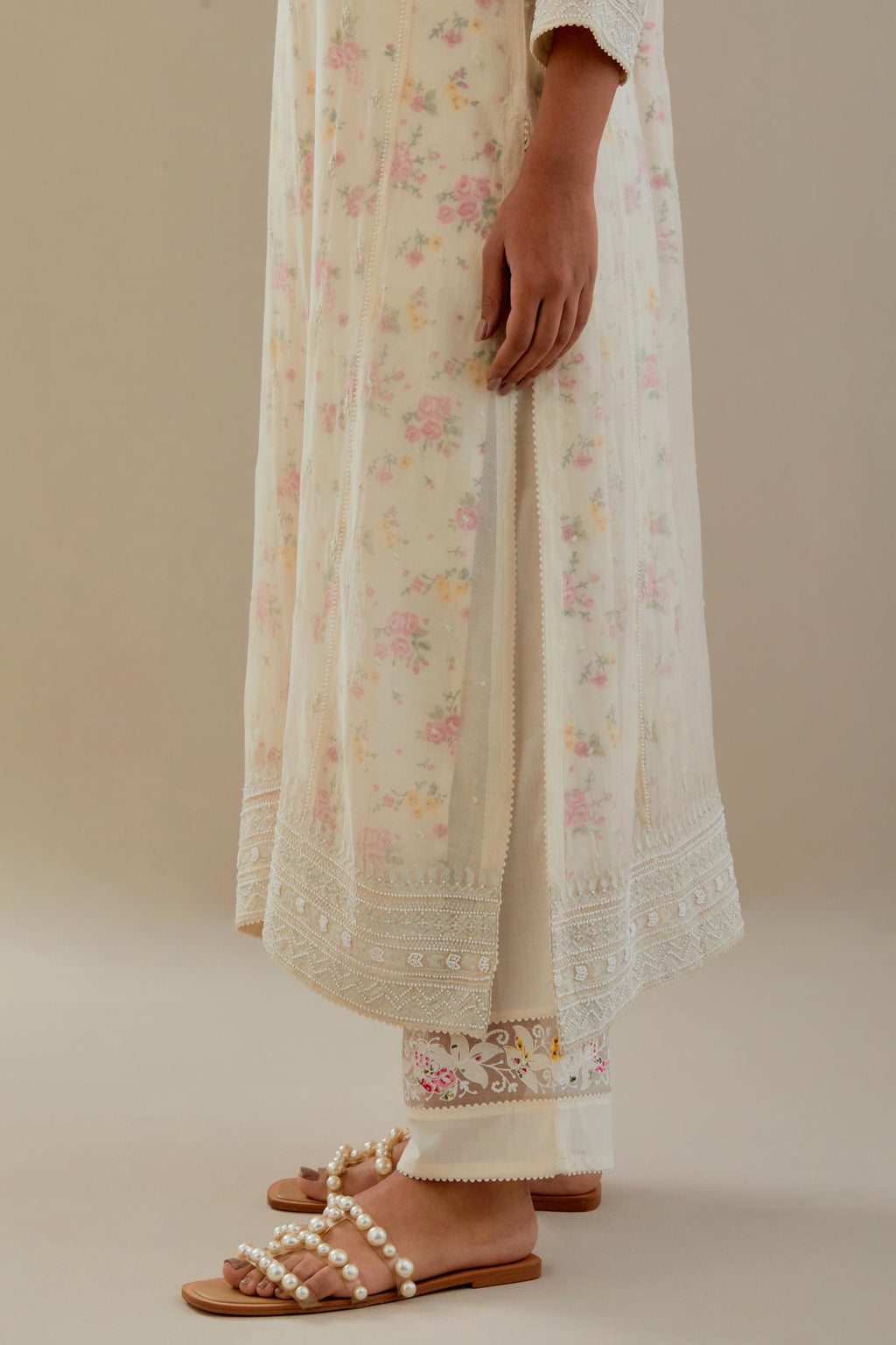 Off white cotton chanderi straight kurta set with heavy embroidered button placket neckline and delicate bead, tassel work at side panel joint seams.