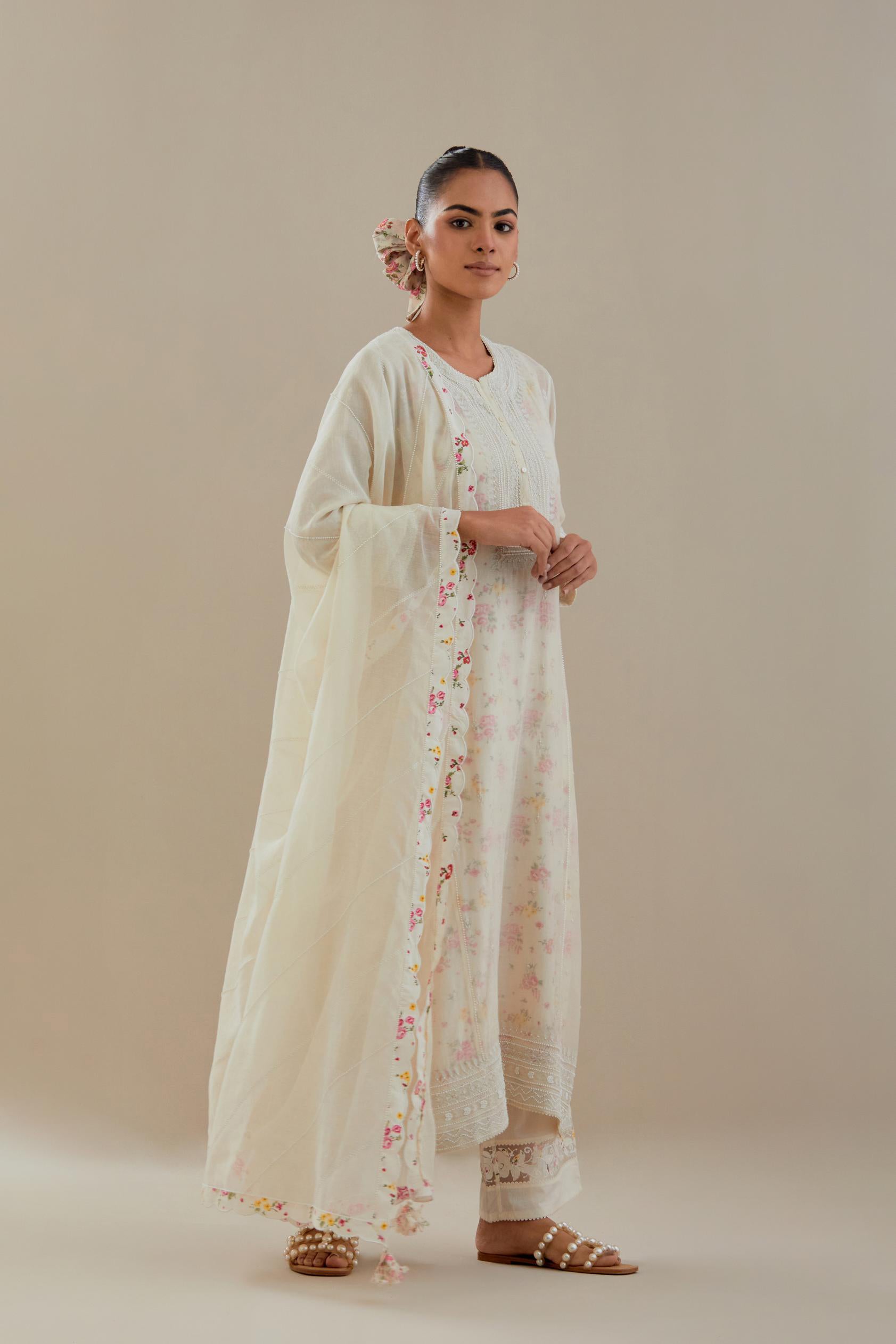 Off white cotton chanderi straight kurta set with heavy embroidered button placket neckline and delicate bead, tassel work at side panel joint seams.