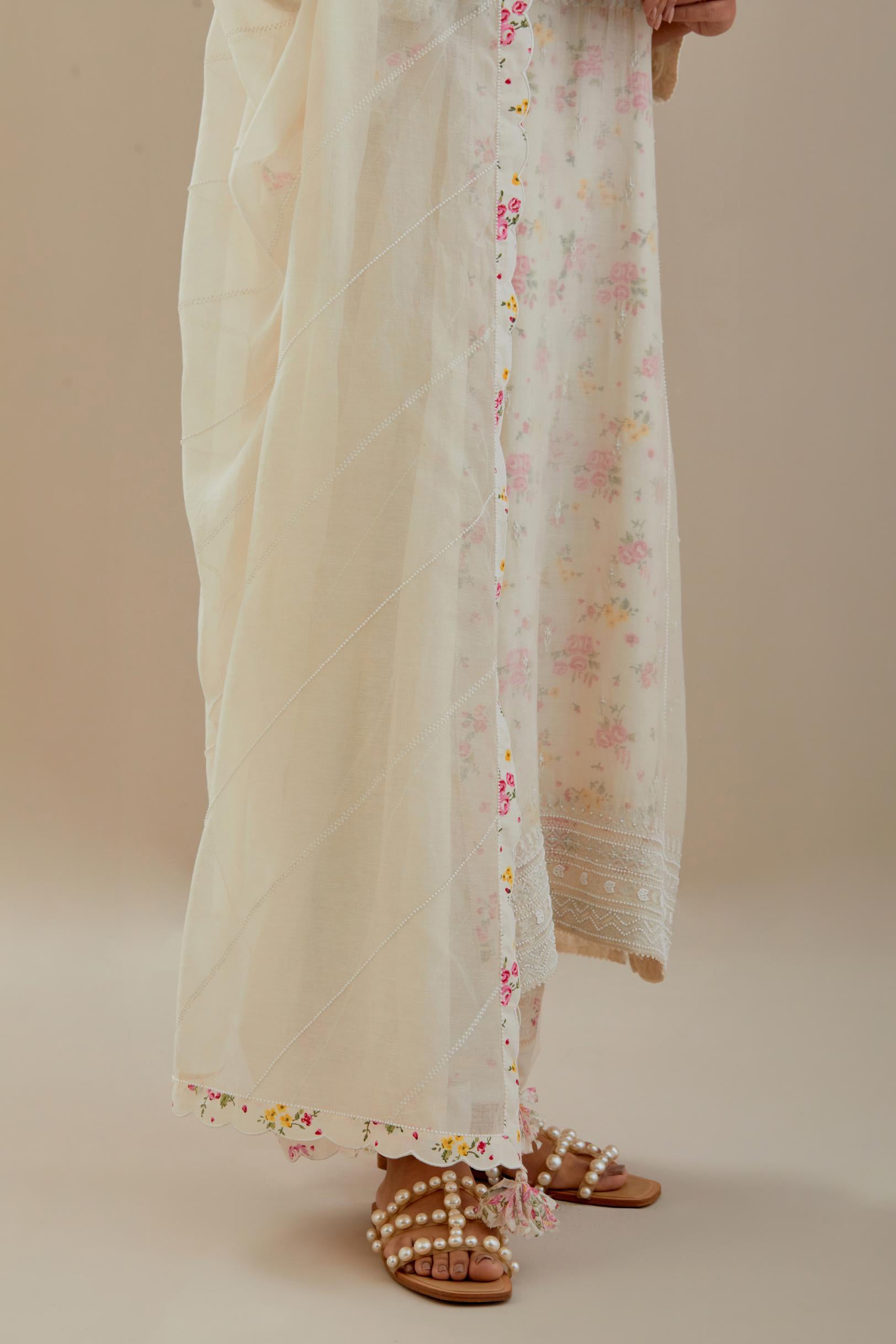 Off white cotton chanderi dupatta with hand block printed cotton scalloped edges and diagonal thread and bead work lines all-over the dupatta.