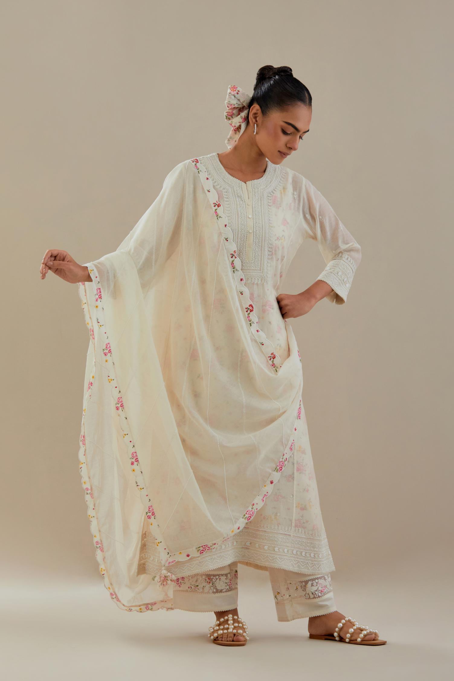 Off white cotton chanderi dupatta with hand block printed cotton scalloped edges and diagonal thread and bead work lines all-over the dupatta.