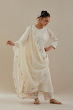 Off white cotton chanderi straight kurta set with heavy embroidered button placket neckline and delicate bead, tassel work at side panel joint seams.