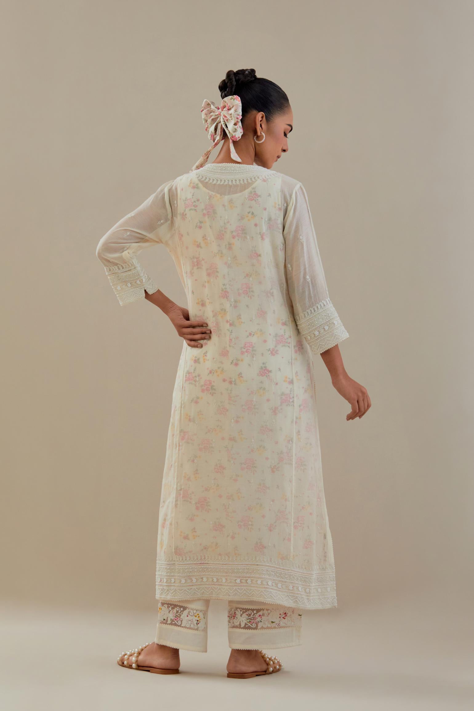 Off white cotton chanderi straight kurta set with heavy embroidered button placket neckline and delicate bead, tassel work at side panel joint seams.