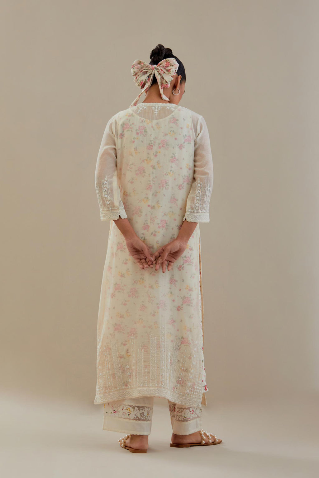 Off white cotton chanderi straight kurta set with off white thread embroidery, highlighted with delicate beaded hand work at neck, sleeve and hem.