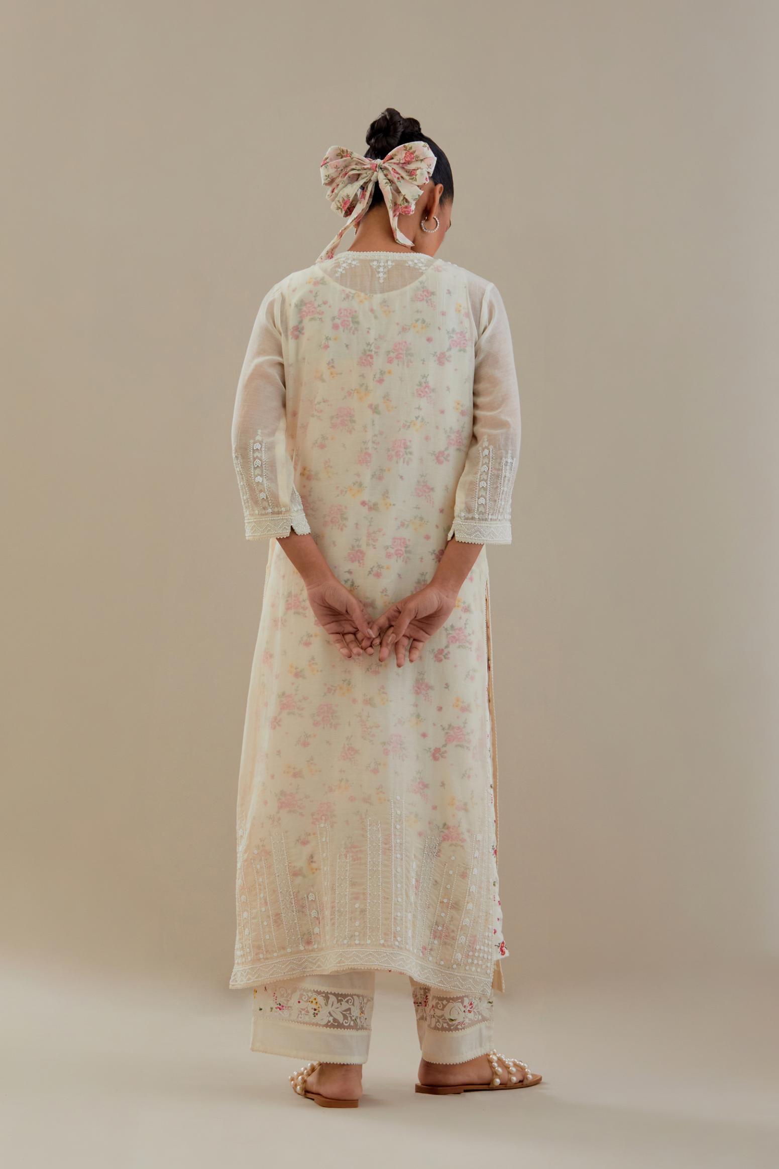 Off white cotton chanderi straight kurta set with off white thread embroidery, highlighted with delicate beaded hand work at neck, sleeve and hem.