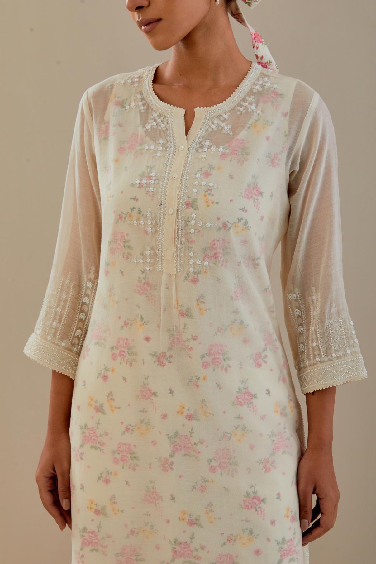 Off white cotton chanderi straight kurta set with off white thread embroidery, highlighted with delicate beaded hand work at neck, sleeve and hem.
