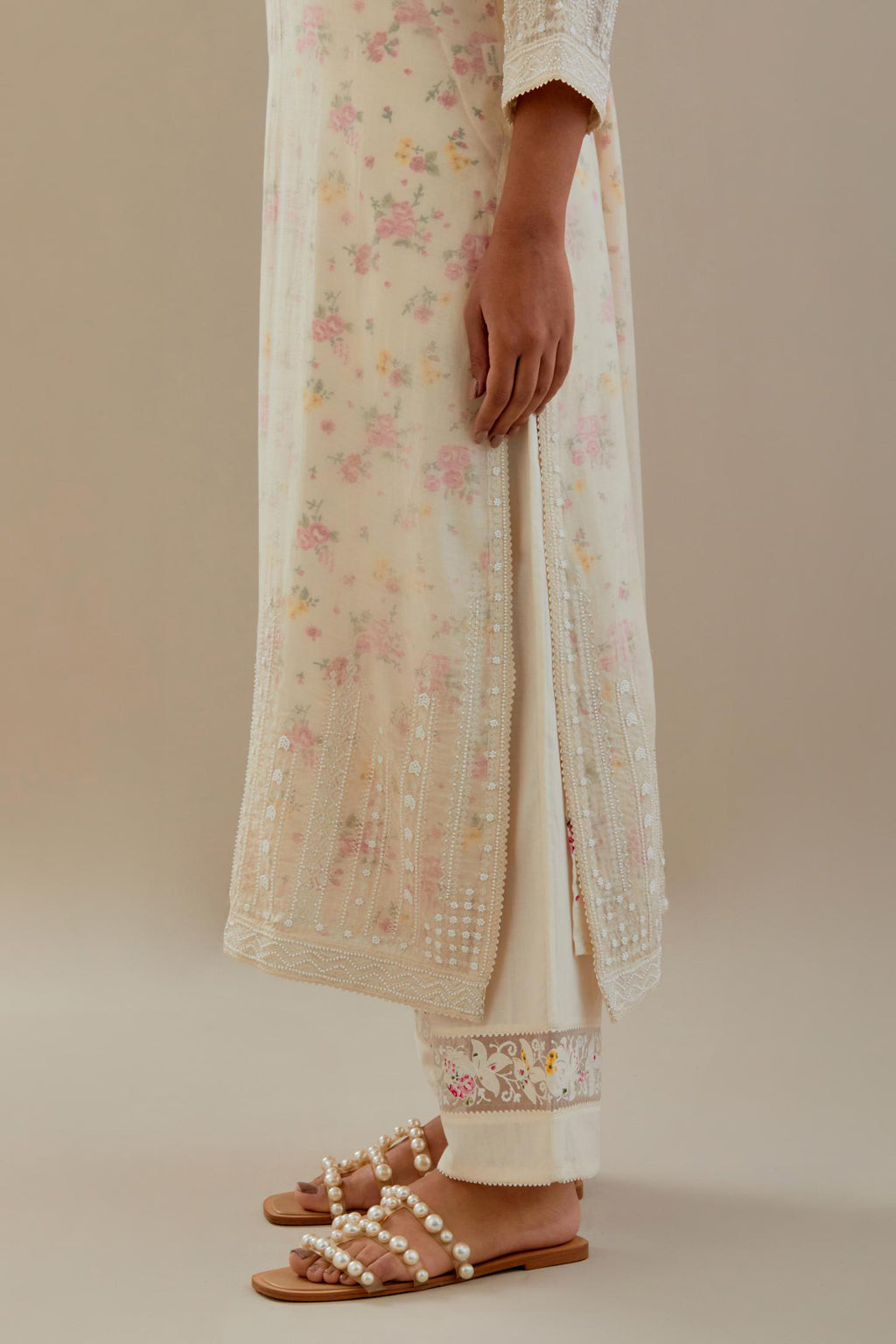 Off white cotton chanderi straight kurta set with off white thread embroidery, highlighted with delicate beaded hand work at neck, sleeve and hem.