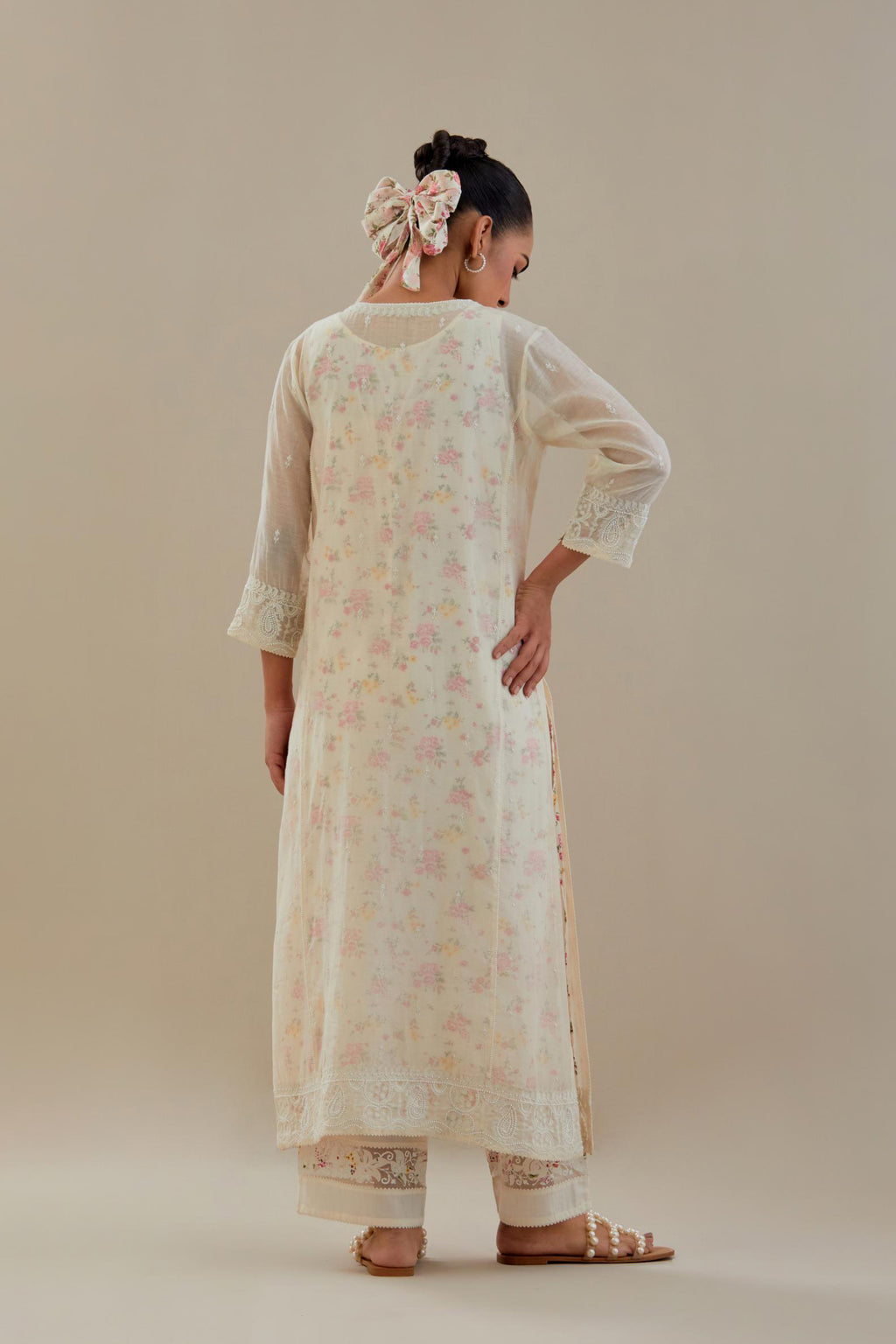 Off white cotton chanderi straight kurta set with embroidered button placket neckline and delicate bead, thread tassel work at side panel joint seams.