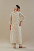 Off white cotton chanderi straight kurta set with embroidered button placket neckline and delicate bead, thread tassel work at side panel joint seams.