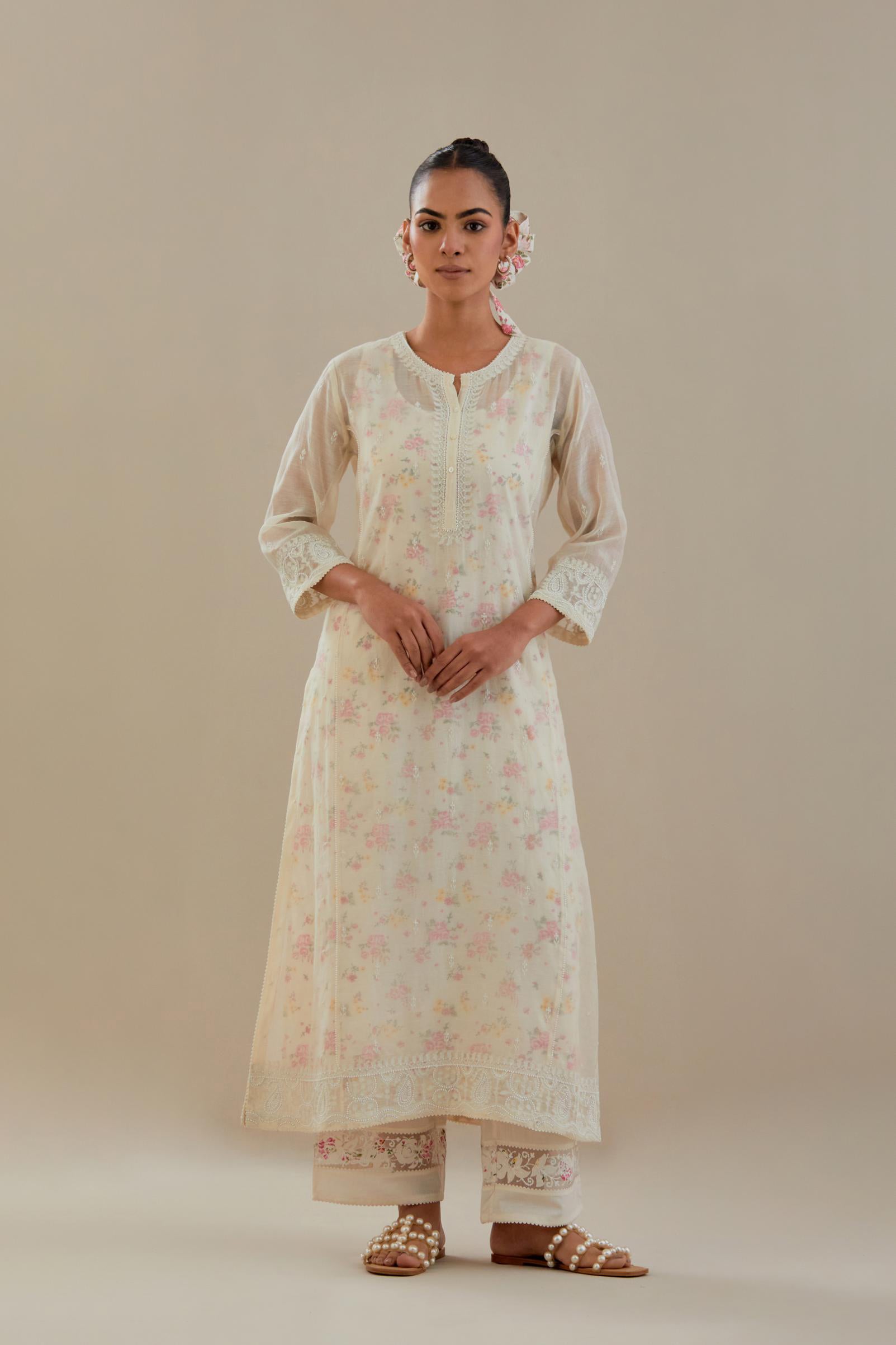Off white cotton chanderi straight kurta set with embroidered button placket neckline and delicate bead, thread tassel work at side panel joint seams.