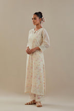 Off white cotton chanderi straight kurta set with embroidered button placket neckline and delicate bead, thread tassel work at side panel joint seams.
