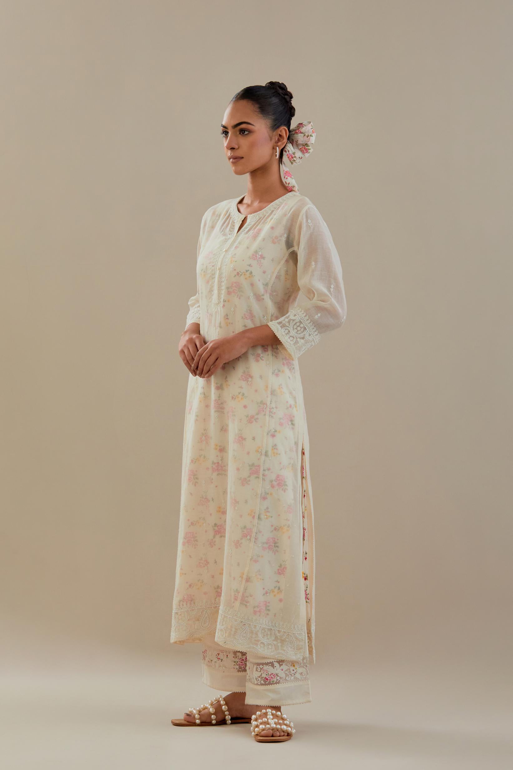 Off white cotton chanderi straight kurta set with embroidered button placket neckline and delicate bead, thread tassel work at side panel joint seams.