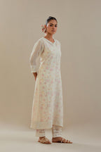 Off white cotton chanderi straight kurta set with embroidered button placket neckline and delicate bead, thread tassel work at side panel joint seams.