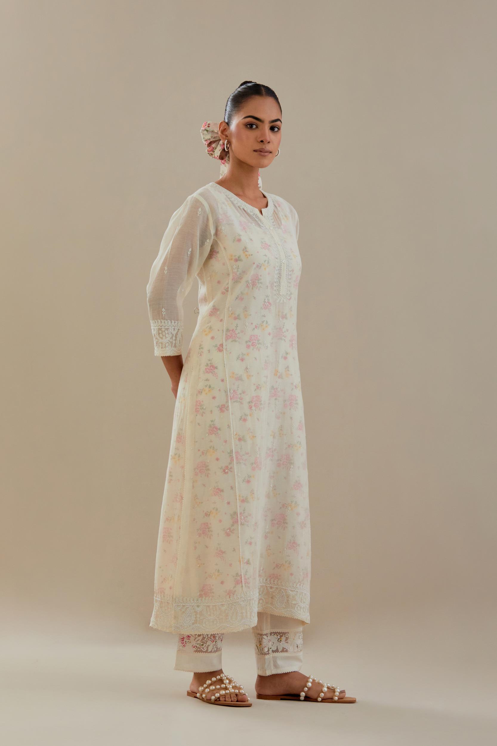 Off white cotton chanderi straight kurta set with embroidered button placket neckline and delicate bead, thread tassel work at side panel joint seams.