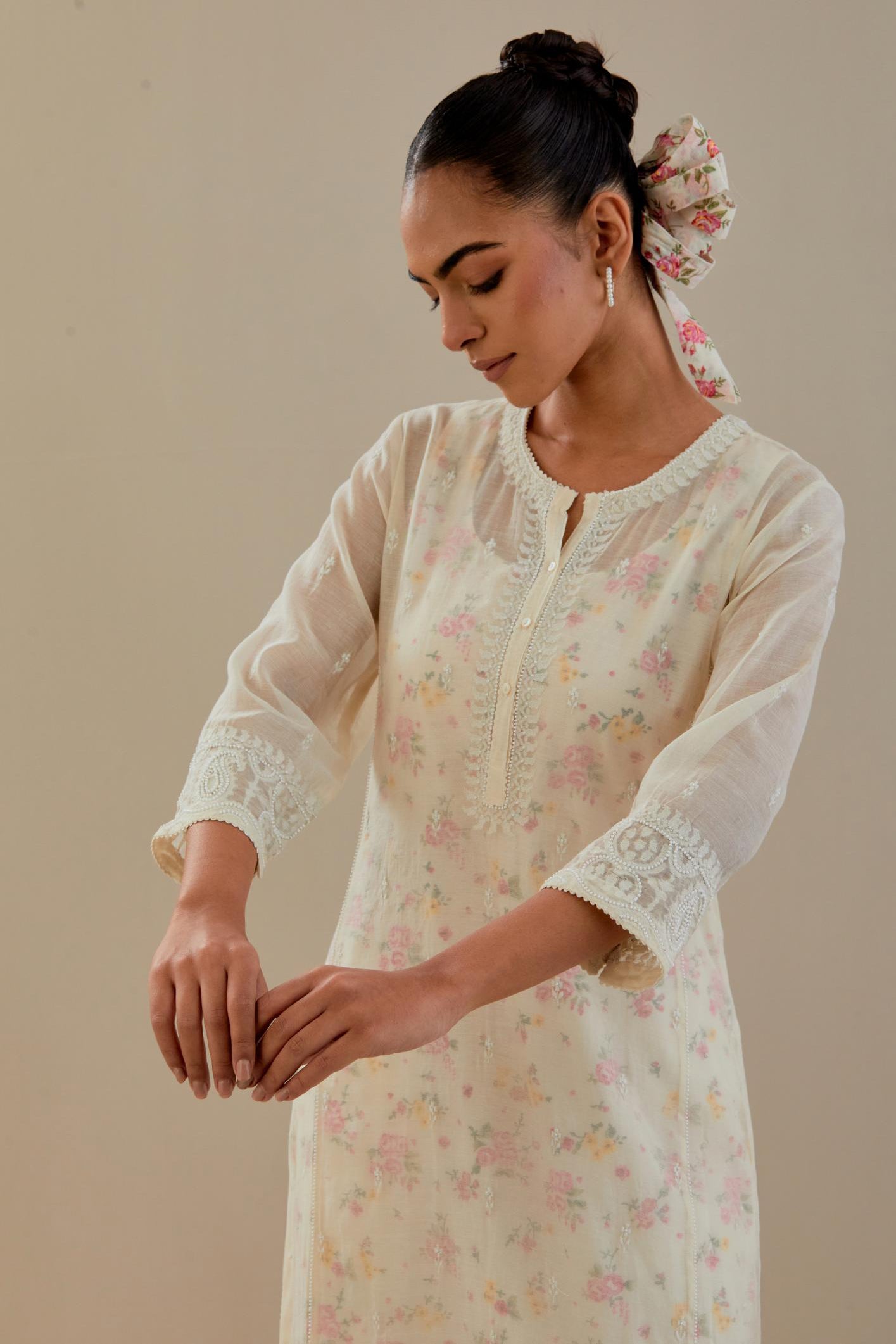 Off white cotton chanderi straight kurta set with embroidered button placket neckline and delicate bead, thread tassel work at side panel joint seams.