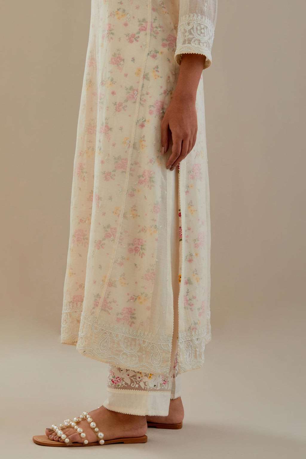 Off white cotton chanderi straight kurta set with embroidered button placket neckline and delicate bead, thread tassel work at side panel joint seams.